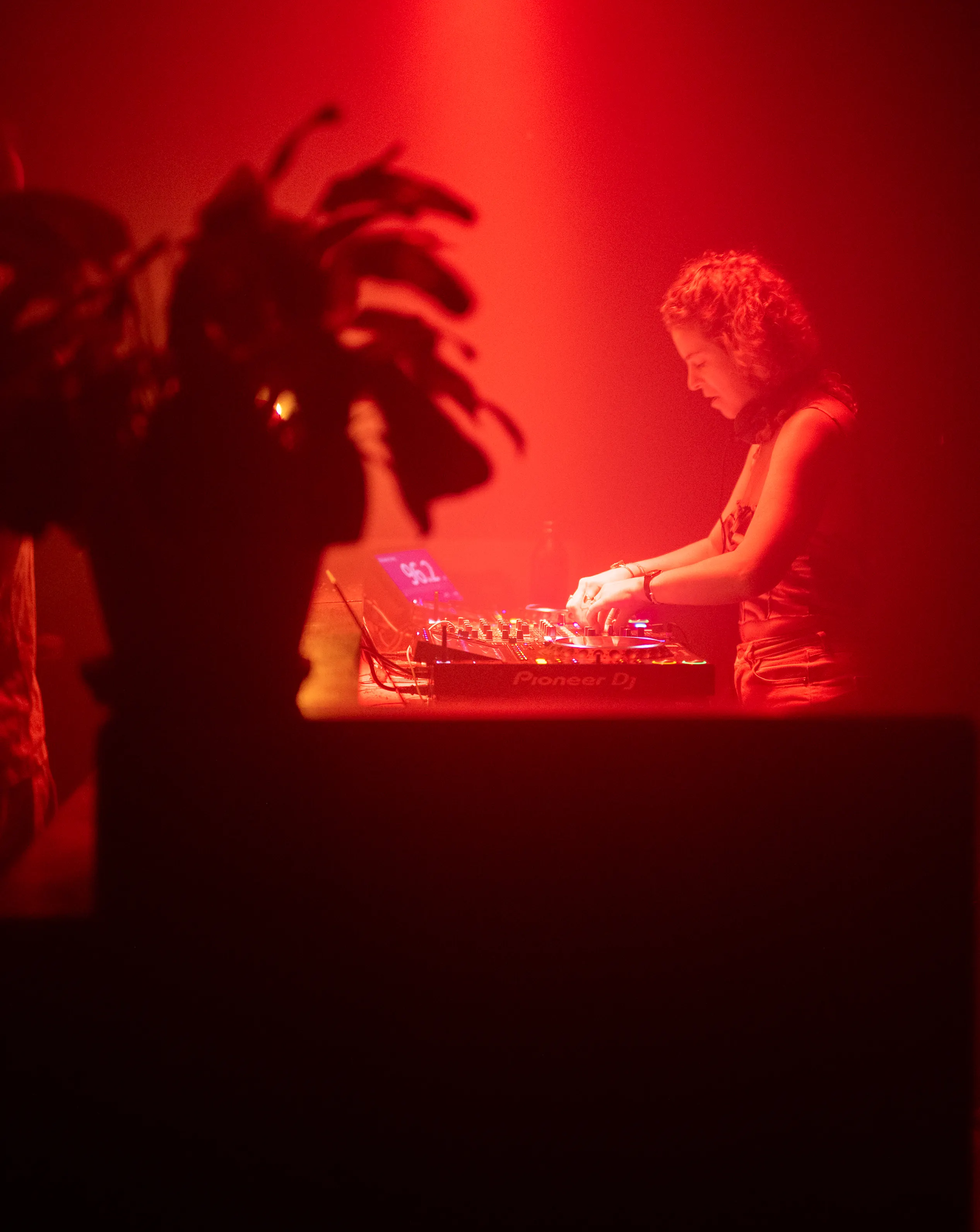 DJ at the decks in red light